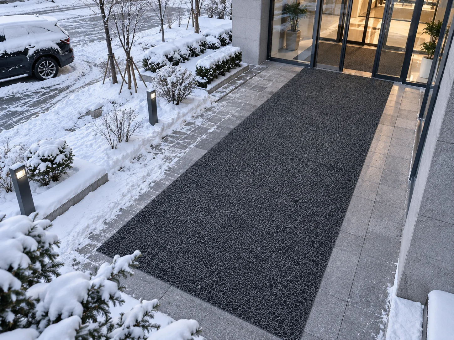 Backing-free PVC coil mat at a snowy building entrance